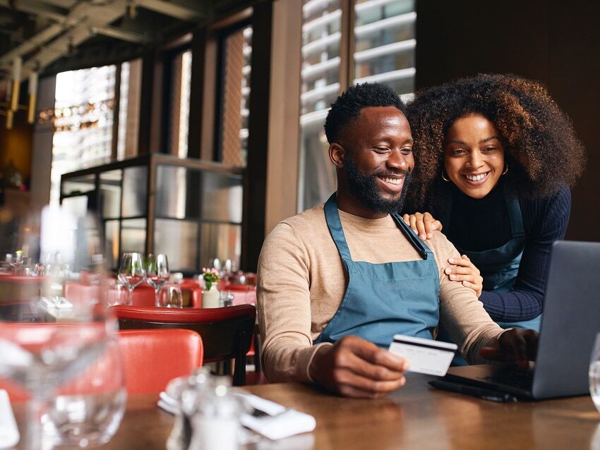 Two restaurant owners making a purchase with business credit card