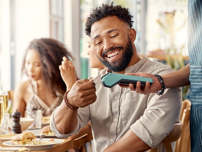 Man using credit card to pay at a restaurant