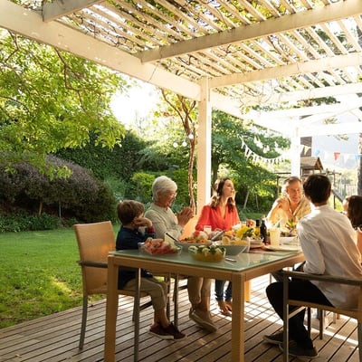Family and grandparents dining on patio