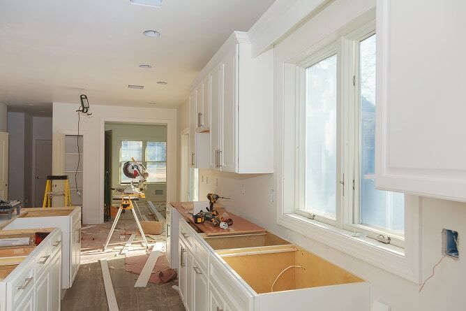 Kitchen being remodeled with tools and materials