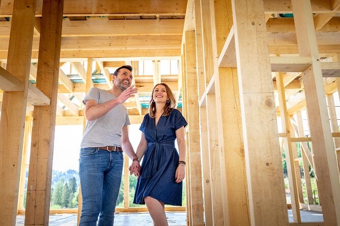 Husband and wife walking through house construction project