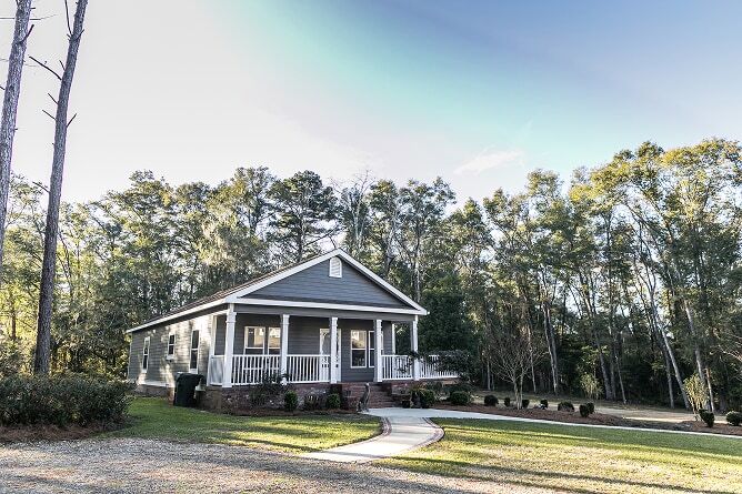  Blue manufactured home with front porch and sidewalk