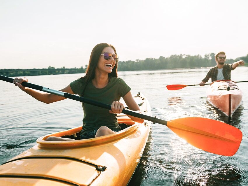 Man and woman in kayaks on a lake