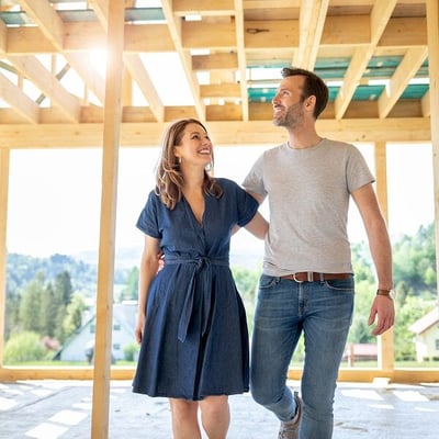 Couple walking through house construction
