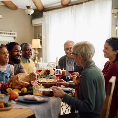 Multi-generational family around dining table 