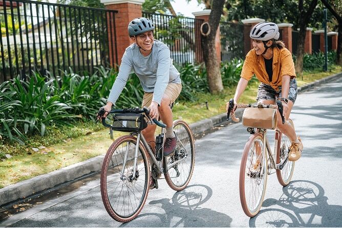 Couple riding bicycles through neighborhood