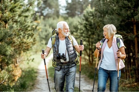 a mature couple hiking in the woods