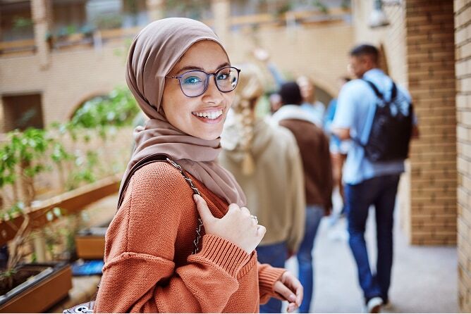 Female student smiling with other students in background